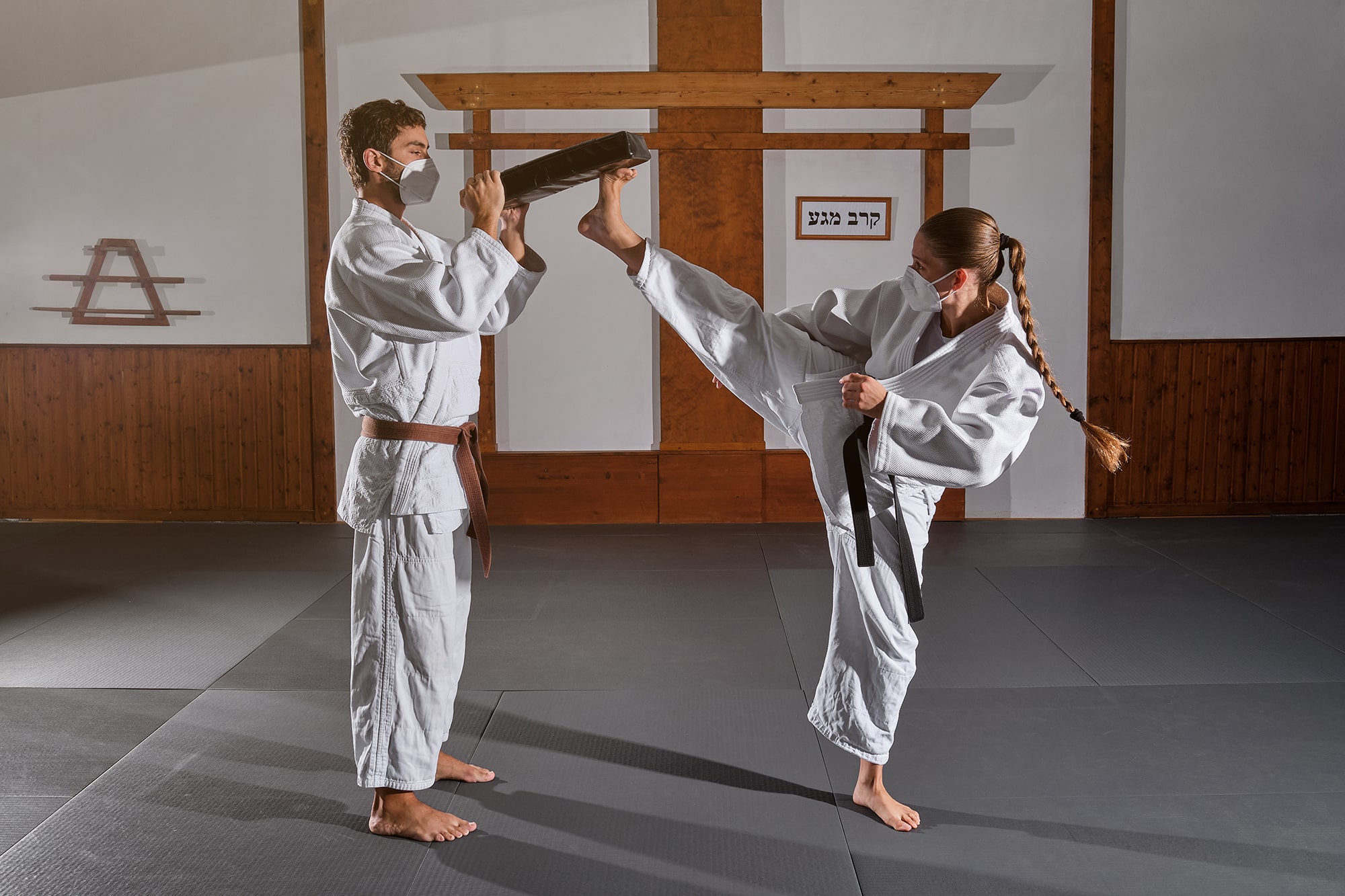 woman kicking a pad